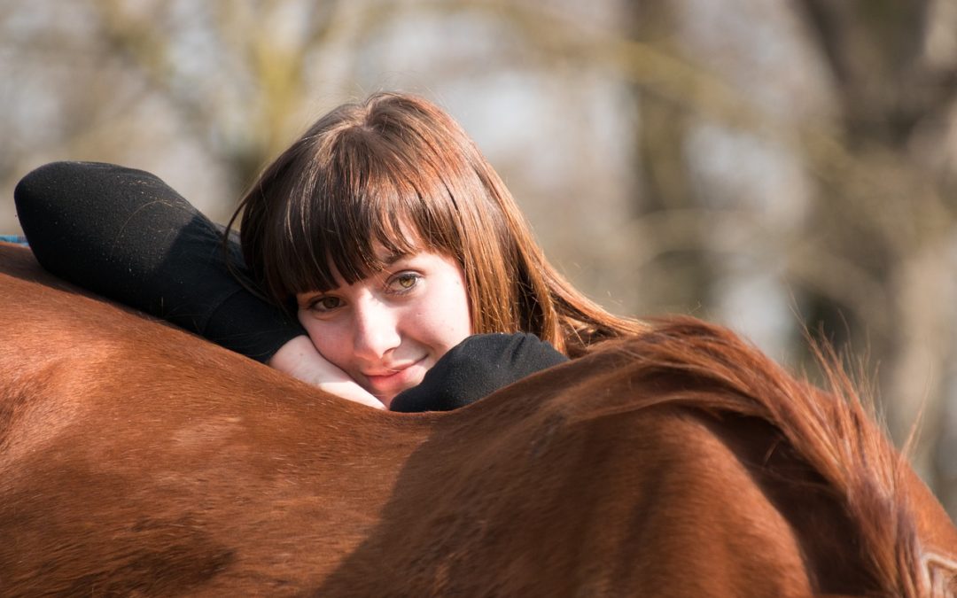woman allowing herself to be at ease with horse