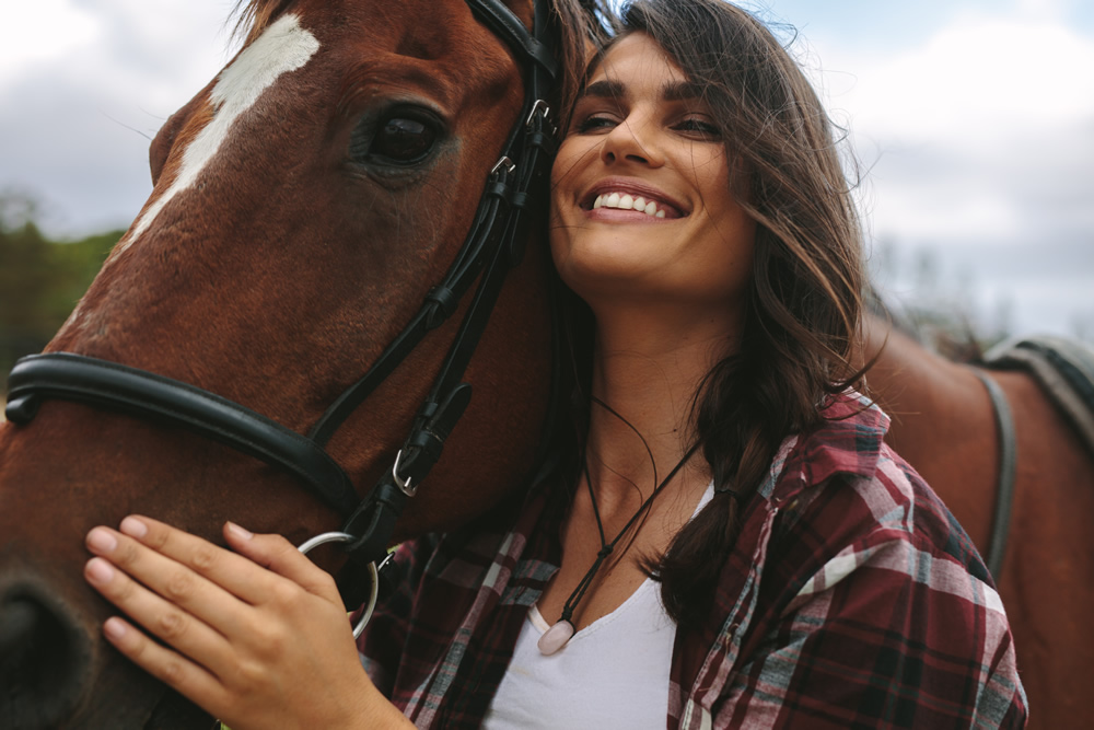 smiling woman with horse blazing new trail